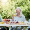 Family sharing a meal together at a table in their back yard